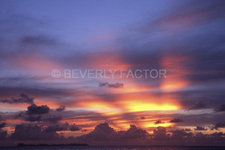 Islands;sunsets;sky;clouds;colorful;blue water;sun;yellow;red;pink;sillouettes;blue;palau micronesia